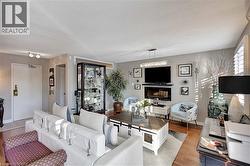 Living area with a glass covered fireplace, a textured ceiling, and wood finished floors - 