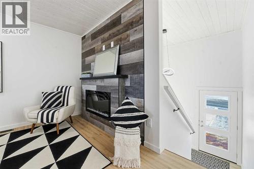 6 Metcalf Way, Lacombe, AB - Indoor Photo Showing Other Room With Fireplace