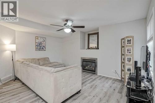 222 Bridleridge Way Sw, Calgary, AB - Indoor Photo Showing Living Room With Fireplace