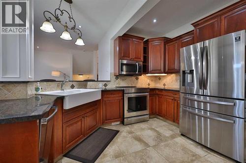 213 E 350 S, Raymond, AB - Indoor Photo Showing Kitchen With Stainless Steel Kitchen