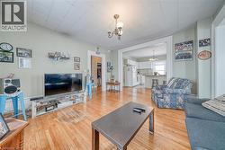 Living area featuring a chandelier and light wood-type flooring - 