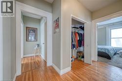 Corridor with light wood-style flooring and baseboards - 