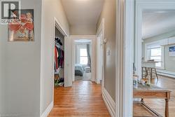 Hallway featuring light wood finished floors and baseboards - 