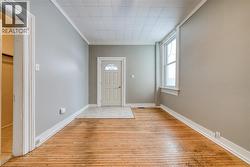 Foyer entrance featuring crown molding and light wood finished floors - 