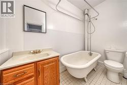 Bathroom with vanity and light tile patterned floors - 