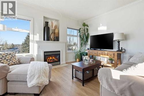 203, 11170 30 Street Sw, Calgary, AB - Indoor Photo Showing Living Room With Fireplace