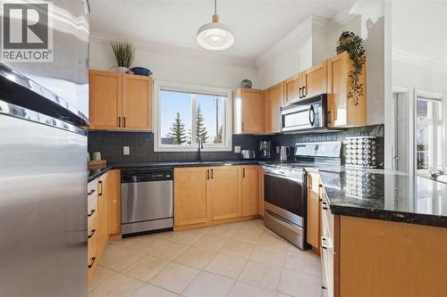 203, 11170 30 Street Sw, Calgary, AB - Indoor Photo Showing Kitchen With Stainless Steel Kitchen With Double Sink