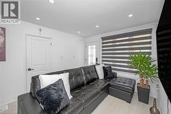 Living area with recessed lighting and light wood finished floors - 