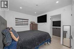 Bedroom featuring light wood finished floors and recessed lighting - 