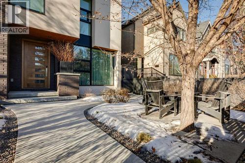 FRONT GARDEN WITH SEATING AREA, ROSES AND PERENNIAL GARDEN - 3813 1A Street Sw, Calgary, AB - Outdoor