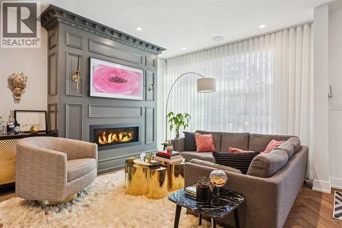 CUSTOM FIREPLACE, HERRINGBONE HARDWOOD FLOORS AND CUSTOM SHEERS - 3813 1A Street Sw, Calgary, AB - Indoor Photo Showing Living Room With Fireplace