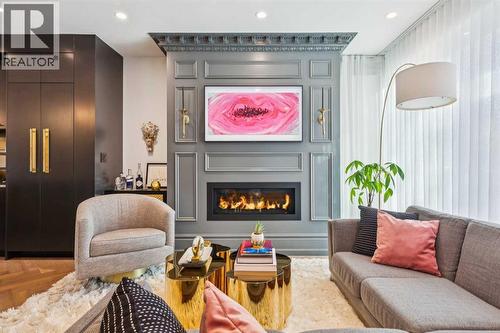 FRAME TV ABOVE THE FIREPLACE IS INCLUDED - 3813 1A Street Sw, Calgary, AB - Indoor Photo Showing Living Room With Fireplace