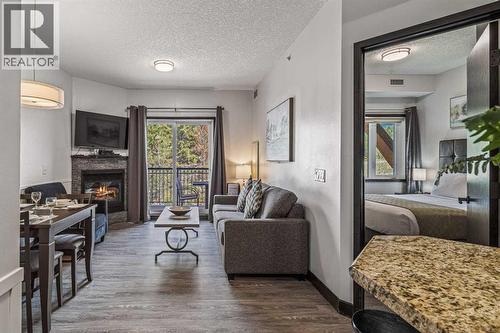 326 Rot. Ef, 901 Mountain Street, Canmore, AB - Indoor Photo Showing Living Room With Fireplace