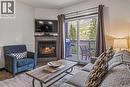 326 Rot. Ef, 901 Mountain Street, Canmore, AB  - Indoor Photo Showing Living Room With Fireplace 