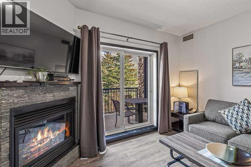 326 Rot. Ef, 901 Mountain Street, Canmore, AB - Indoor Photo Showing Living Room With Fireplace