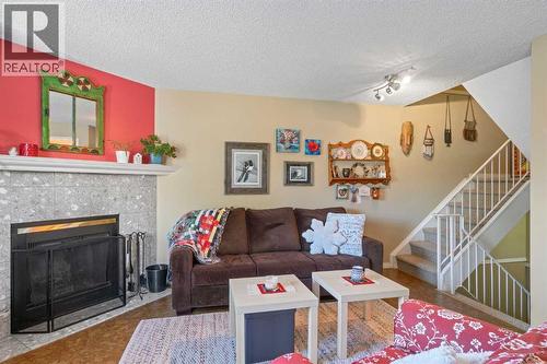 43, 200 Shawnessy Drive Sw, Calgary, AB - Indoor Photo Showing Living Room With Fireplace