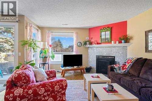 43, 200 Shawnessy Drive Sw, Calgary, AB - Indoor Photo Showing Living Room With Fireplace