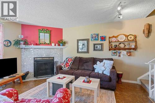 43, 200 Shawnessy Drive Sw, Calgary, AB - Indoor Photo Showing Living Room With Fireplace