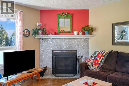 43, 200 Shawnessy Drive Sw, Calgary, AB - Indoor Photo Showing Living Room With Fireplace