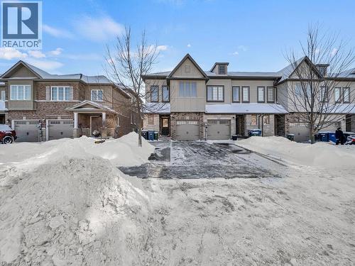 View of front of house with an attached garage and brick siding - 144 Summit Ridge Drive, Guelph, ON - Outdoor With Facade