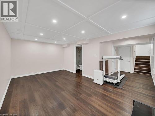 Exercise area featuring recessed lighting, dark wood-style flooring, and coffered ceiling - 144 Summit Ridge Drive, Guelph, ON - Indoor