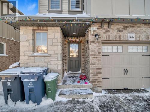Snow covered property entrance featuring stone siding - 144 Summit Ridge Drive, Guelph, ON - Outdoor