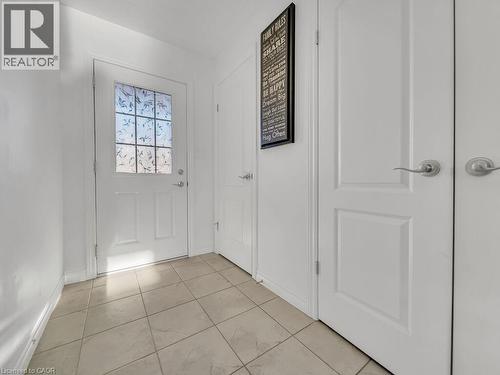 Doorway to outside with baseboards and tile patterned flooring - 144 Summit Ridge Drive, Guelph, ON - Indoor Photo Showing Other Room
