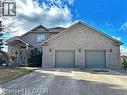 View of front of property featuring driveway and a garage - 158 River Run Road, Drayton, ON  - Outdoor With Facade 