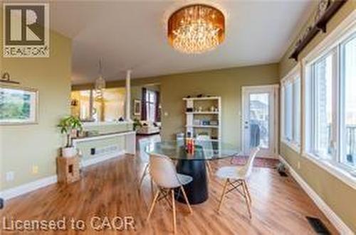 Dining area with a chandelier and wood finished floors - 158 River Run Road, Drayton, ON - Indoor Photo Showing Dining Room