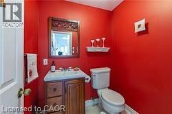 Half bathroom featuring vanity and toilet - 