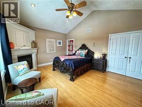 Bedroom with light wood-type flooring, a ceiling fan, and high vaulted ceiling - 158 River Run Road, Drayton, ON - Indoor Photo Showing Bedroom