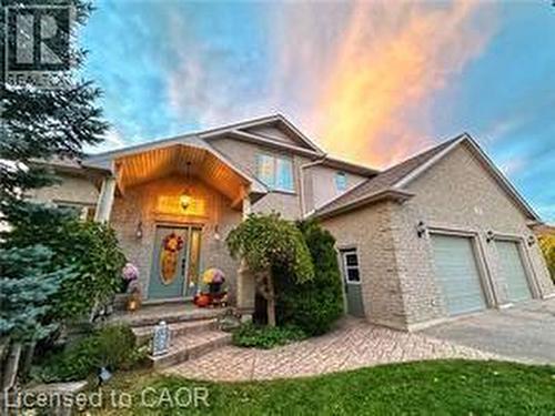 View of front facade with a garage and driveway - 158 River Run Road, Drayton, ON - Outdoor