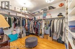 Walk in closet featuring light wood-style flooring - 