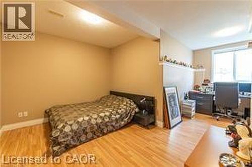 Bedroom featuring light wood-type flooring and an office area - 158 River Run Road, Drayton, ON - Indoor Photo Showing Bedroom