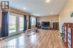 Workout area with wood finished floors and recessed lighting - 