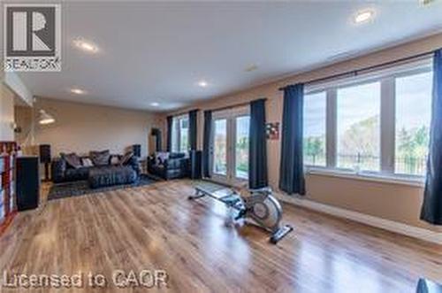 Exercise area with wood finished floors, recessed lighting, and french doors - 158 River Run Road, Drayton, ON - Indoor Photo Showing Other Room