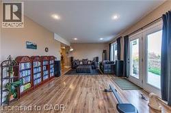 Exercise room with wood finished floors and recessed lighting - 