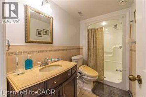 Full bath featuring a stall shower, vanity, and a wainscoted wall - 158 River Run Road, Drayton, ON - Indoor Photo Showing Bathroom