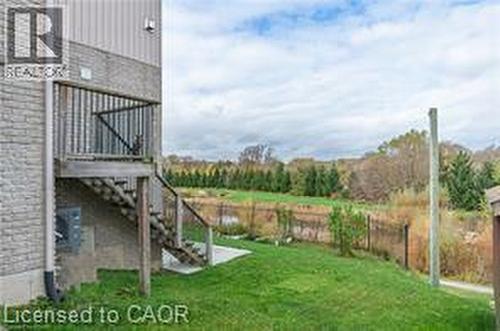 Fenced backyard with stairway and a patio - 158 River Run Road, Drayton, ON - Outdoor