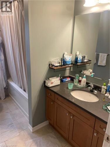 Full bath with shower / bath combo, vanity, and light tile patterned floors - 229 Pine Glen Crescent, Kitchener, ON - Indoor Photo Showing Bathroom