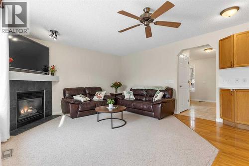 176 Cougar Ridge Circle Sw, Calgary, AB - Indoor Photo Showing Living Room With Fireplace