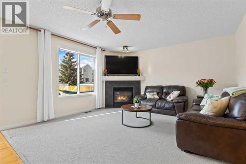 176 Cougar Ridge Circle Sw, Calgary, AB - Indoor Photo Showing Living Room With Fireplace