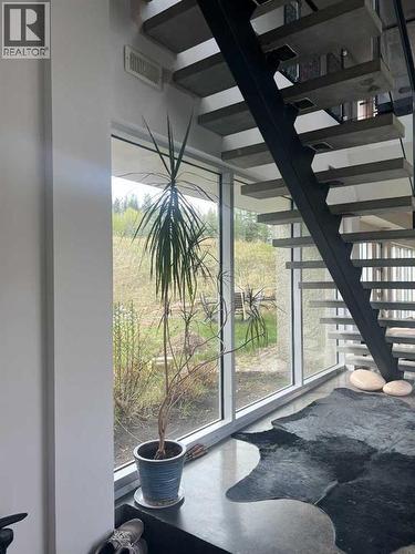 Stairs to upper level - 31 Williams Place, Bragg Creek, AB - Indoor Photo Showing Other Room