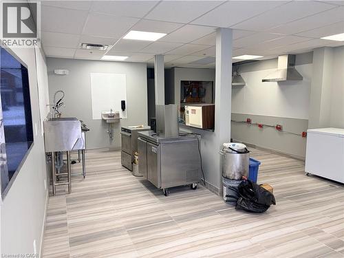 Kitchen with a drop ceiling and wall chimney exhaust hood - 354 King Street N Unit# 3, Waterloo, ON 