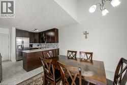 Dining room featuring a chandelier and a textured ceiling - 