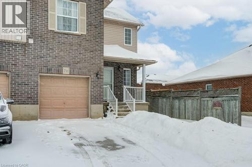View of front of house with brick siding and an attached garage - 711 Southwood Way, Woodstock, ON - Outdoor With Exterior