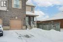 View of front of house with brick siding and an attached garage - 711 Southwood Way, Woodstock, ON  - Outdoor With Exterior 