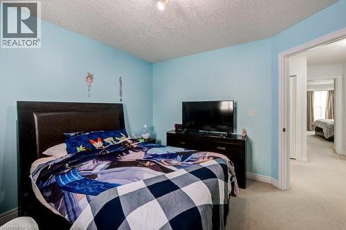 Bedroom featuring carpet flooring and a textured ceiling - 711 Southwood Way, Woodstock, ON - Indoor Photo Showing Bedroom