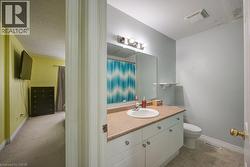 Full bath featuring vanity, a shower with shower curtain, and a textured ceiling - 