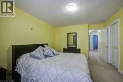Bedroom with carpet floors and a textured ceiling - 